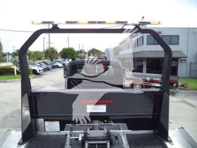 Truck bed with rollover equipment rack and Jerr-Dan branding visible on the side panel.