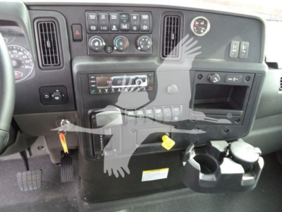 Dashboard view of a truck cab showing instrument cluster, control panel, climate knobs, radio, auxiliary switches, and cup holders.