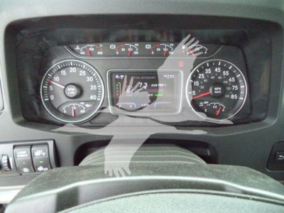 Dashboard of a new 2026 International MV rollback truck showing speedometer gauges and central digital display.
