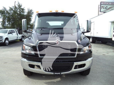Front view of a new 2026 International MV rollback truck showing grille badge and chrome bumper.