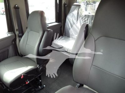 Interior of 2026 International MV rollback truck showing front seats and cab area with gray upholstery