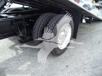 Truck rear dual tires and suspension undercarriage of the 2026 International MV rollback truck showing dual rear wheels and undercarriage components.