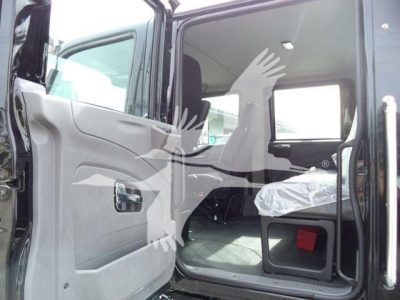 International MV truck cab interior side view showing open door and seating area.