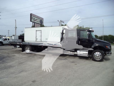 International MV pickup truck with a long box body and a large rectangular cargo box on the back, side view, in a dealership lot.