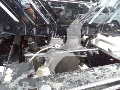 Truck chassis and engine bay components with metal framing and hoses visible (International MV)