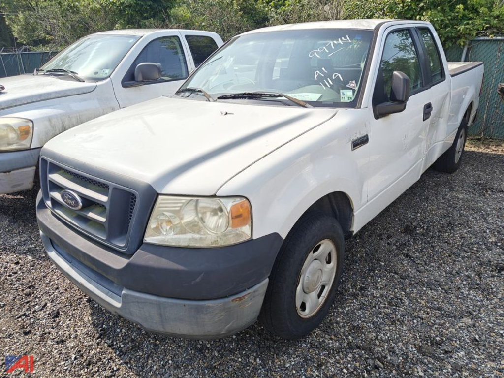 Ford F-150 extended cab pickup truck in front, white exterior, front grille with Ford emblem, left-side view with two-tone bumper