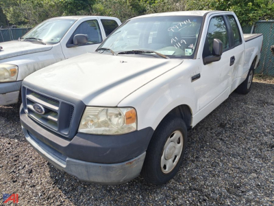 Ford F-150 extended cab pickup truck in front, white exterior, front grille with Ford emblem, left-side view with two-tone bumper