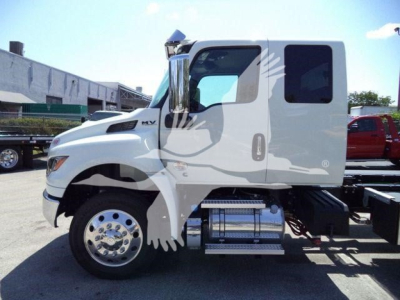 International MV truck cab side view showing chrome fuel tanks and steps