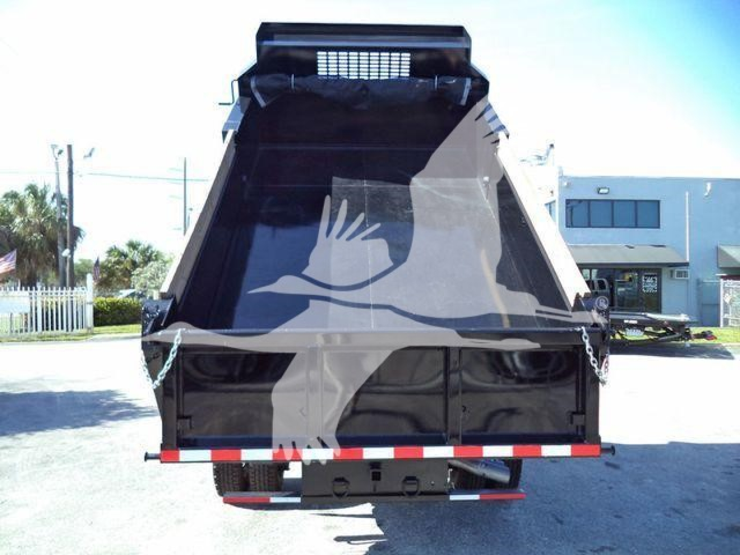 2019 Ford F550 dump truck bed with rear view, showing dump bed and tailgate with reflective safety tape.