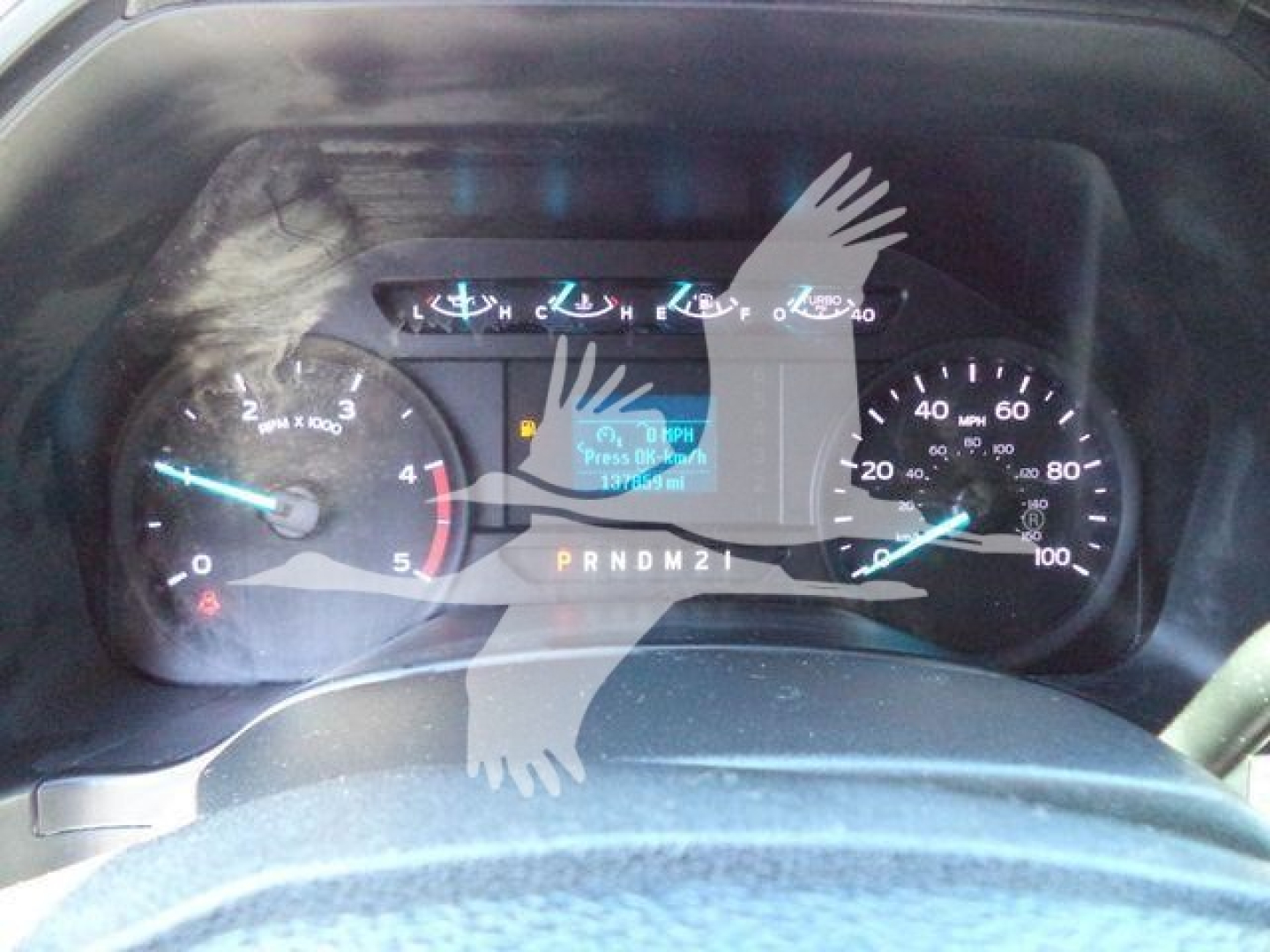 Ford F-550 instrument cluster with RPM gauge, speedometer, and digital display showing PRNDM21 gear indicator.