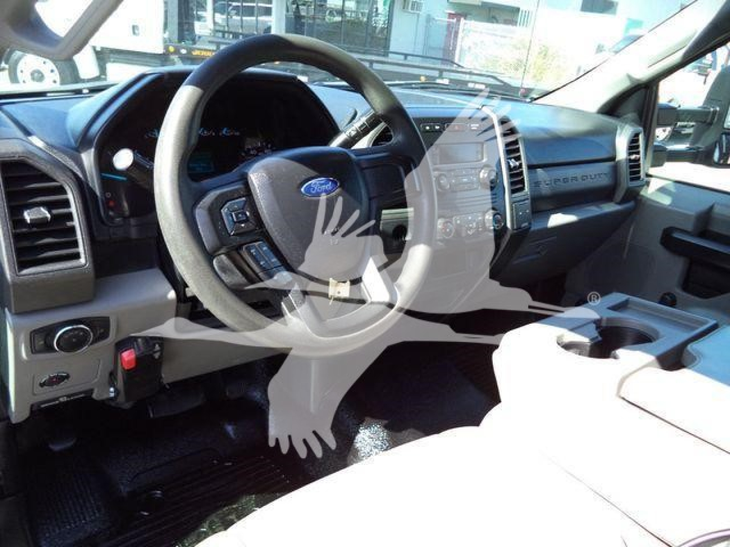 Ford F-550 interior cockpit with steering wheel, dashboard, and center console visible in a used dump truck.