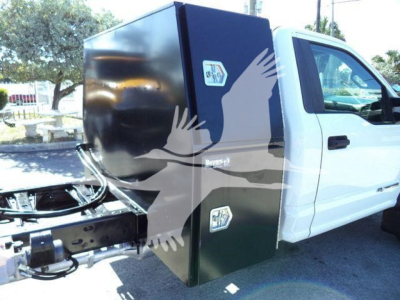 Ford F-550 dump truck cab with a large black utility box mounted behind the cab; stickers on the box; white truck cab visible; stock number T00690FM not visible in image.