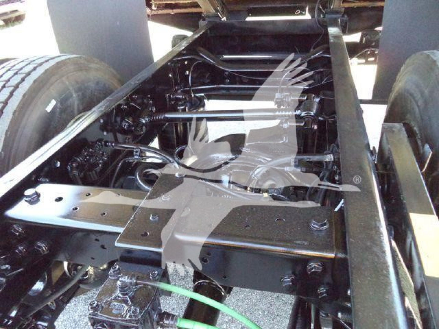 Truck chassis undercarriage showing frame rails, suspension components, and drive line on a 2019 International Durastar 4300 chassis.