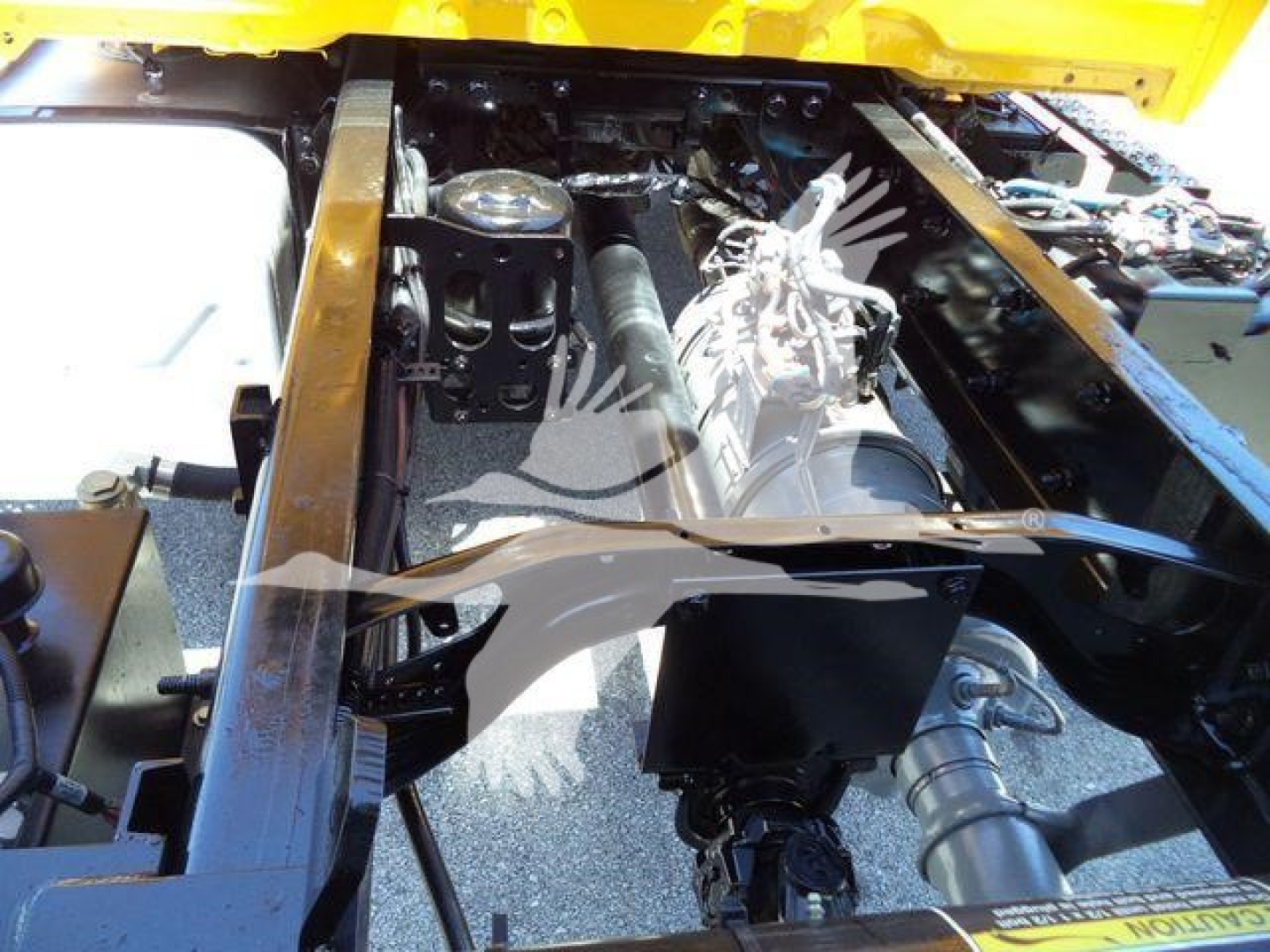 Chassis view of a 2019 International Durastar 4300 truck showing engine bay components and frame rails.