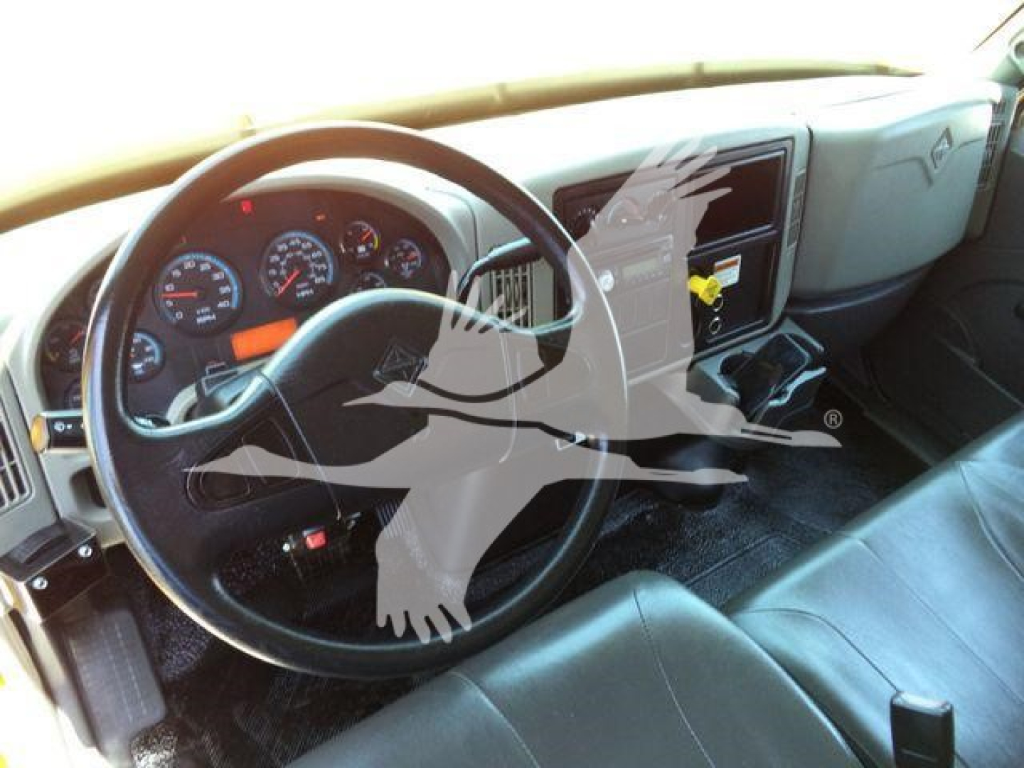 Interior of a 2019 International Durastar 4300 truck showing steering wheel, dashboard gauges, and center console with gear shifter.