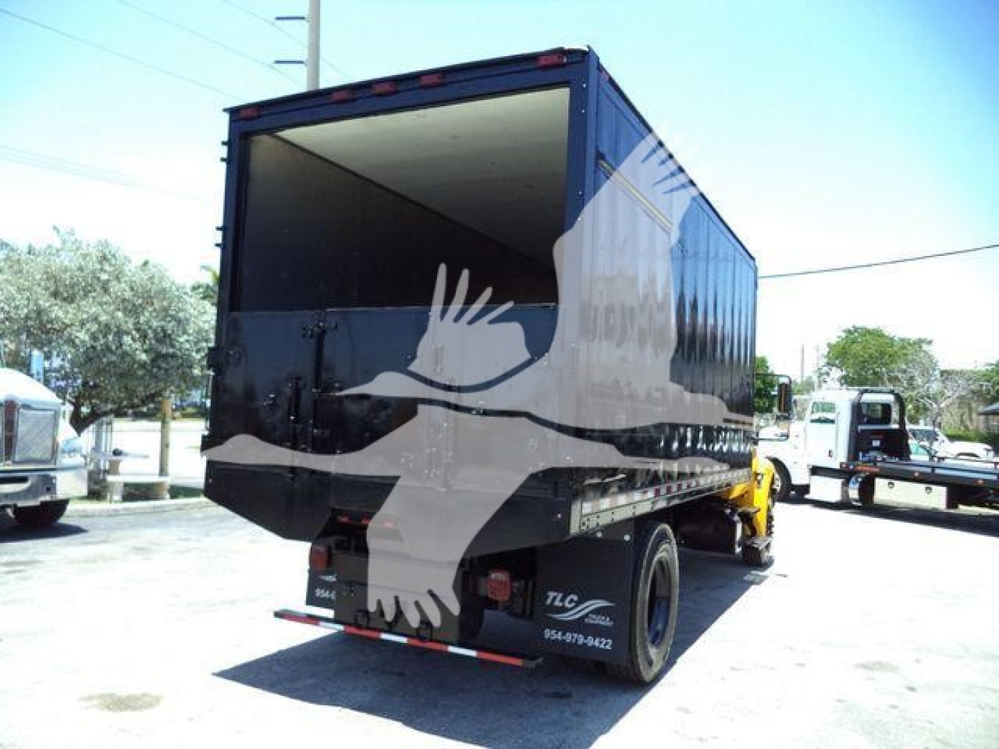 Dump truck bed of a 2019 International Durastar 4300 with an open cargo area and rear bumper, viewed from the left rear side.