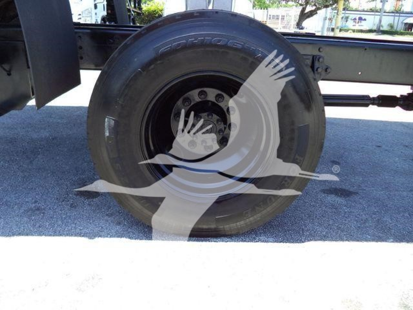 Wheel and tire of a 2019 International Durastar 4300 chassis showing the tire and hub with part of the chassis frame visible.