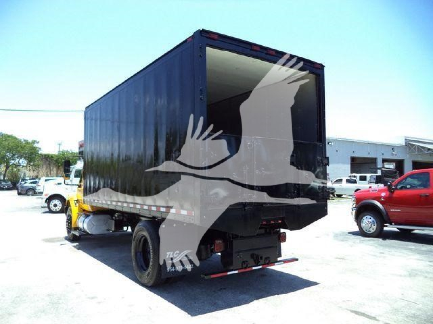 2019 International Durastar 4300 dump truck body side view showing cargo bed open at rear and chassis wheels