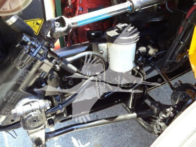 Truck engine bay showing hydraulic lines and reservoir in a 2019 International Durastar 4300 with chipper equipment.