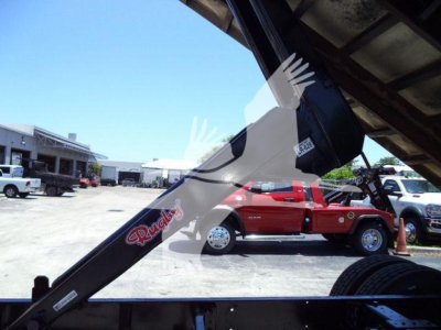 Truck-mounted chipper on a 2019 International Durastar 4300 chassis, side view showing chute and body with 'Rooke' logo, other trucks in background.