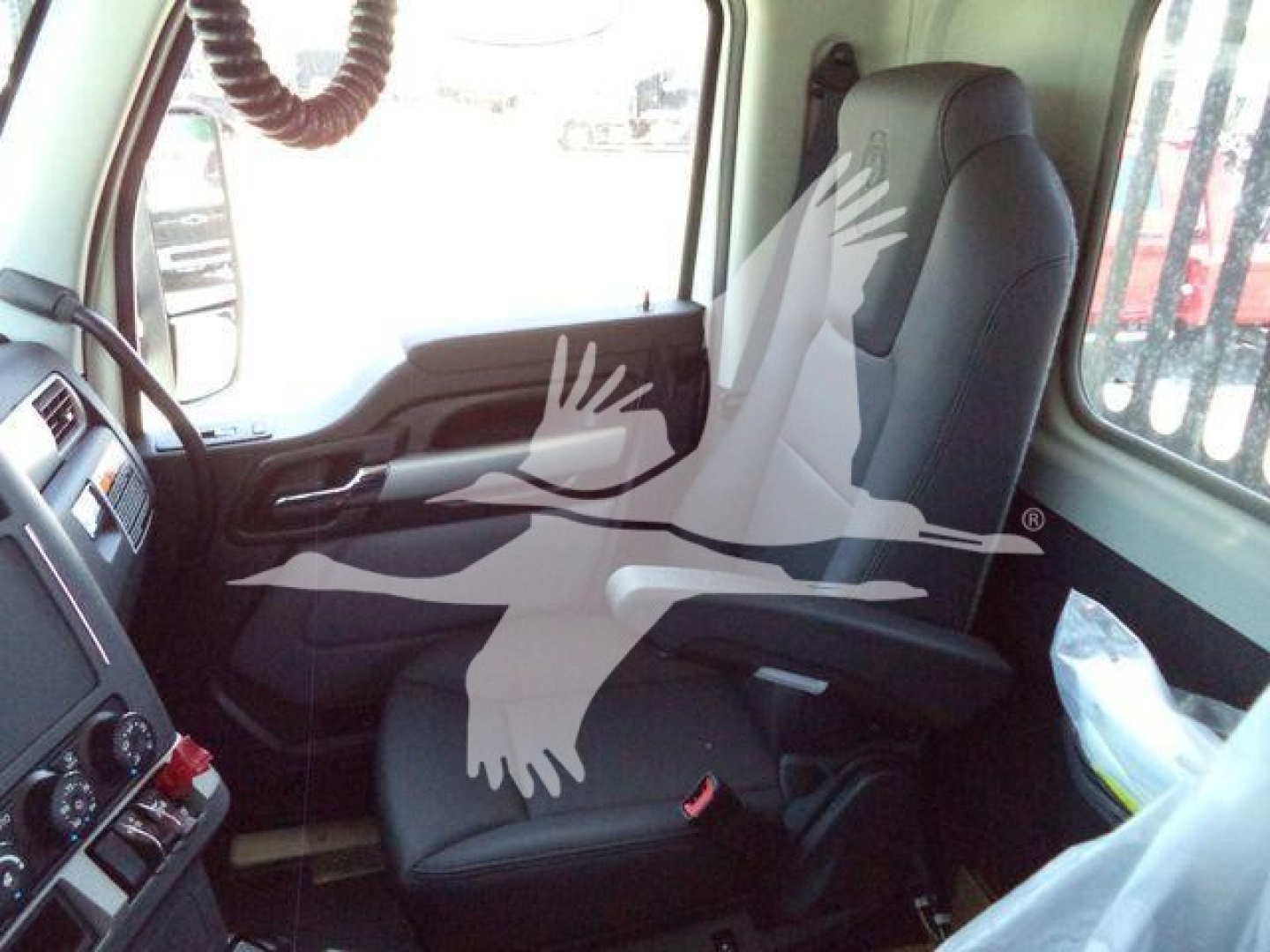 Kenworth T880 truck interior showing driver seat and dash area with steering wheel and control panel.