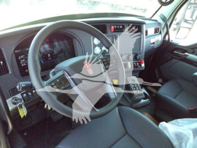 Kenworth T880 truck cab interior showing steering wheel and dashboard gauges