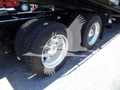 Kenworth T880 rollback trailer showing dual rear wheels and tire treads in view.