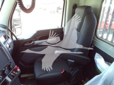Kenworth T880 truck interior showing driver seat and dash area with steering wheel and control panel.