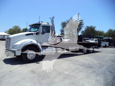 Kenworth T880 rollback truck front-left view showing large chrome wheels and cab with a long chassis.