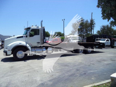 Kenworth T880 rollback truck in white with long lowboy trailer profile, side view, stock number J11612FM visible in listing.