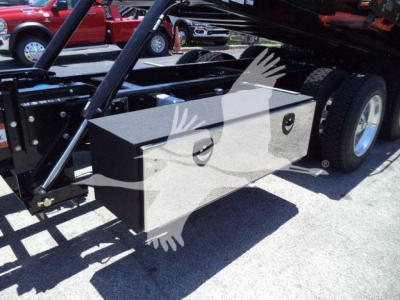 Kenworth T880 rollback truck undercarriage with metal storage toolbox mounted near wheel well.