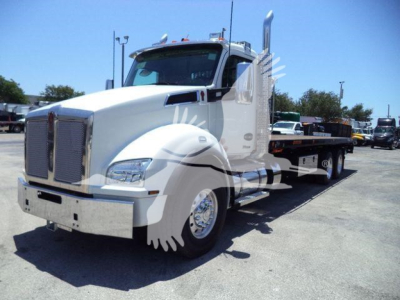 Kenworth T880 truck in a lot, front-left view, featureless white cab with chrome grille; no legible labels or stickers visible on the body.