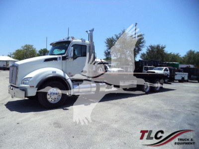 Kenworth T880 rollback truck in lot with reflection overlay. Visible text includes 'TLC Truck & Equipment' watermark across the image.