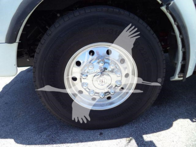 Kenworth T880 wheel and chrome hub showing tire and wheel with reflection; no other text visible.