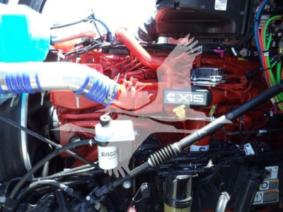 Kenworth T880 engine bay showing X15 badge and various hoses and components including coolant reservoir and filters.