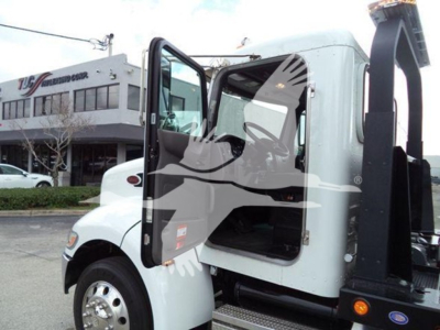 Peterbilt 337 rollback truck cab open door showing interior and hydraulic arm