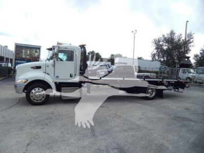 Peterbilt 337 rollback tow truck side view showing flatbed and cab mirror text not legible