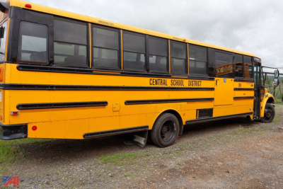 Yellow Freightliner C2 Saf-T-Liner school bus side and rear view showing Central School District lettering and black stripes.