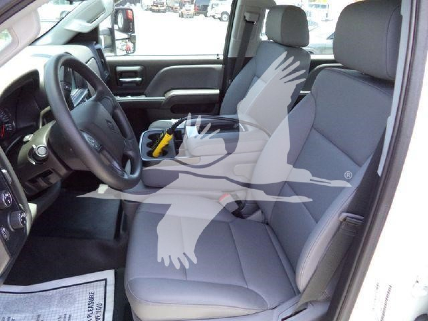 Truck interior showing front driver and passenger seats, steering wheel, and dashboard. Interior text: none clearly legible.