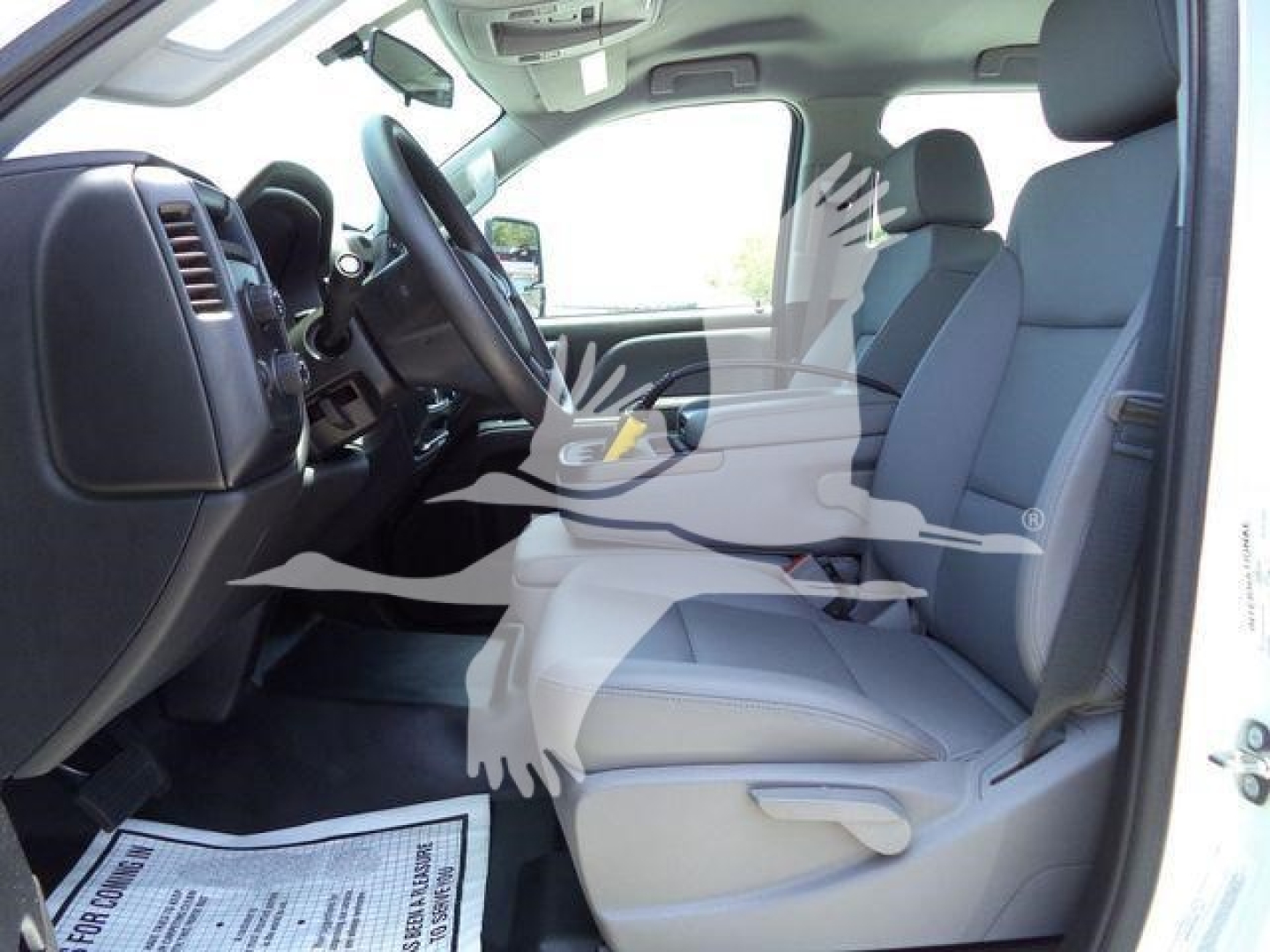Interior of a white 2023 International CV truck cabin showing front seats and dashboard.