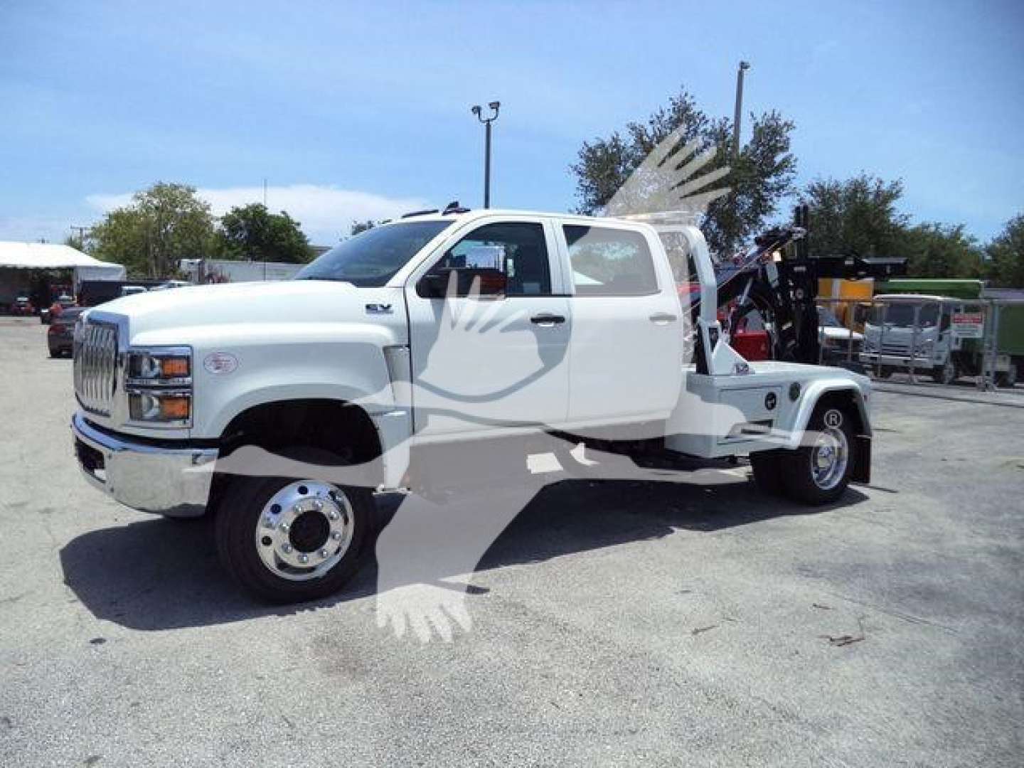 White 2023 International CV tow truck with crane/winch, side view showing dual rear wheels and extended cab.