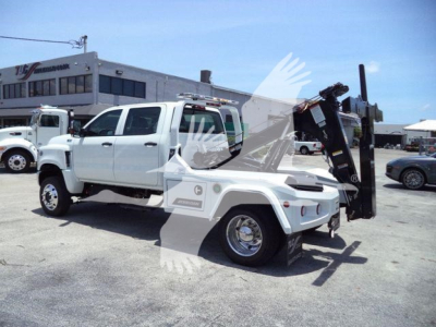 2023 International CV trucks towing winch setup with white cab and black mounted equipment in a dealership lot