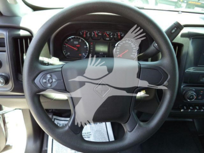 Steering wheel and dashboard of a 2023 International CV truck showing gauge cluster and steering wheel emblem.
