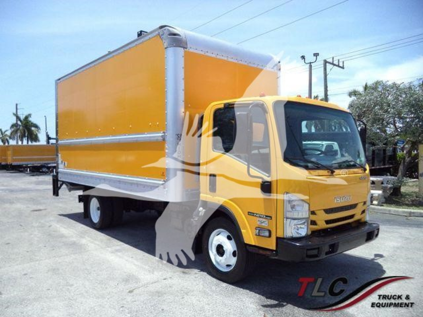 Isuzu NPR HD box truck with yellow cab and large orange box. Front view with logo and headlights visible.