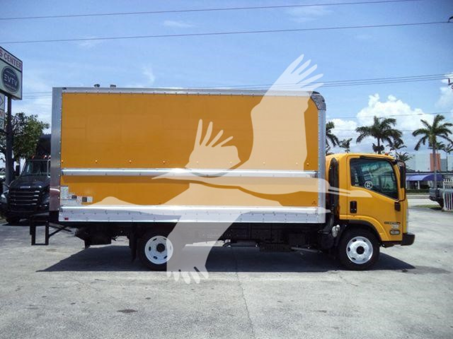 Isuzu NPR HD box truck in service showing bright orange cargo box and yellow cab, side profile with wheel wells and rear dual axle area.
