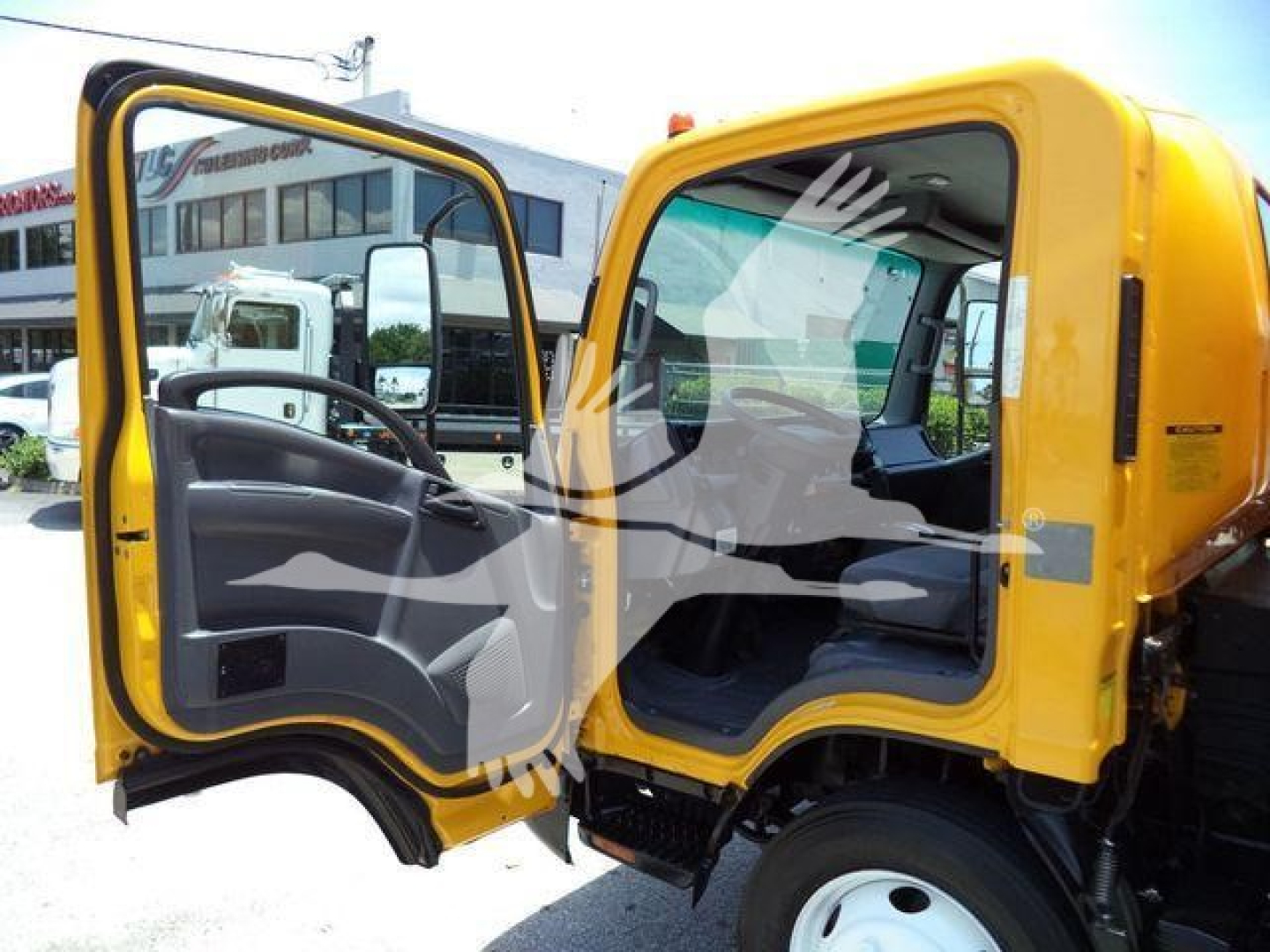 Isuzu NPR-HD cab interior showing open door and yellow exterior