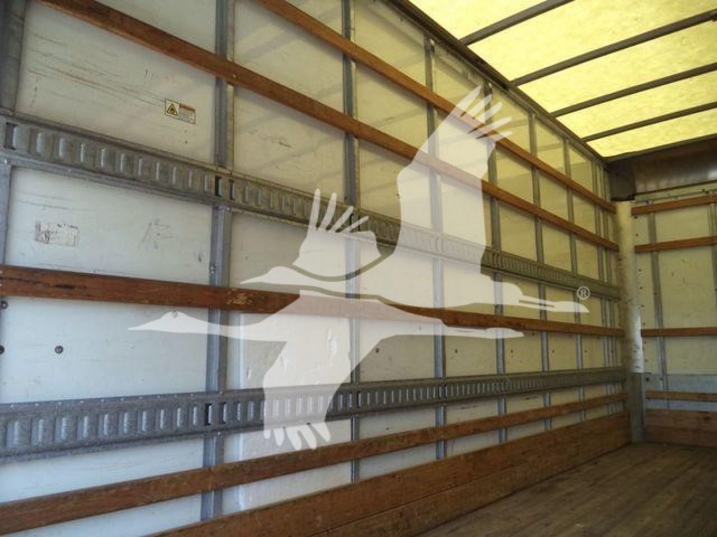 Isuzu NPR-HD truck cargo area interior with metal slat walls and wooden floor, stock photo watermark overlay.