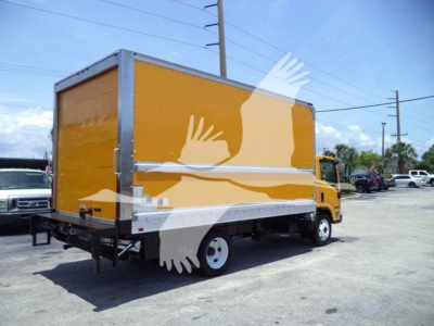 Isuzu NPR HD box truck from rear three-quarter view showing bright yellow cargo box and white cab trim.