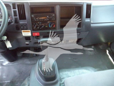Isuzu NPR HD cab interior showing dashboard controls and gear shifter.