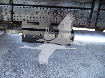 Isuzu NPR HD underside of truck showing exhaust/muffler and rear undercarriage with perforated metal shield.